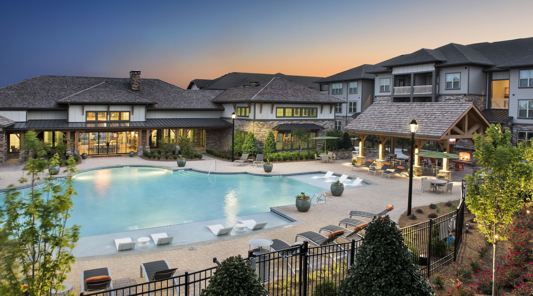 a courtyard with a pool and chairs