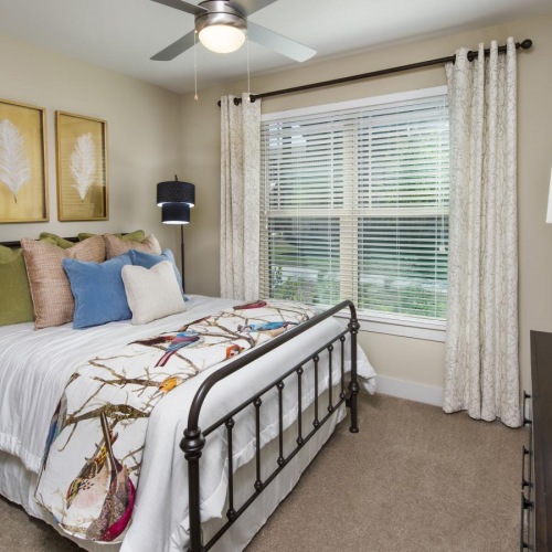 a bedroom with a bed and a fan