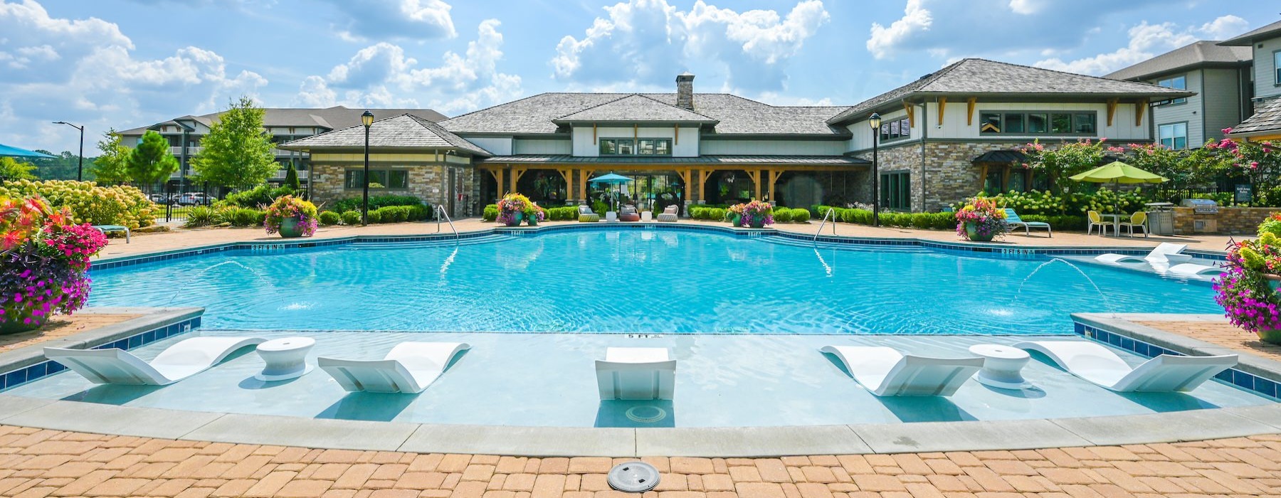 a swimming pool with lounge chairs